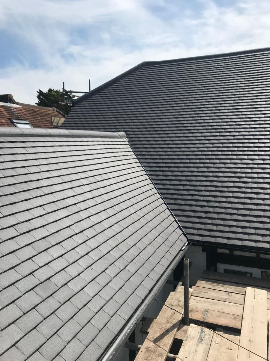 Two adjoining pitched tiled roofs freshly re-covered, West Sussex